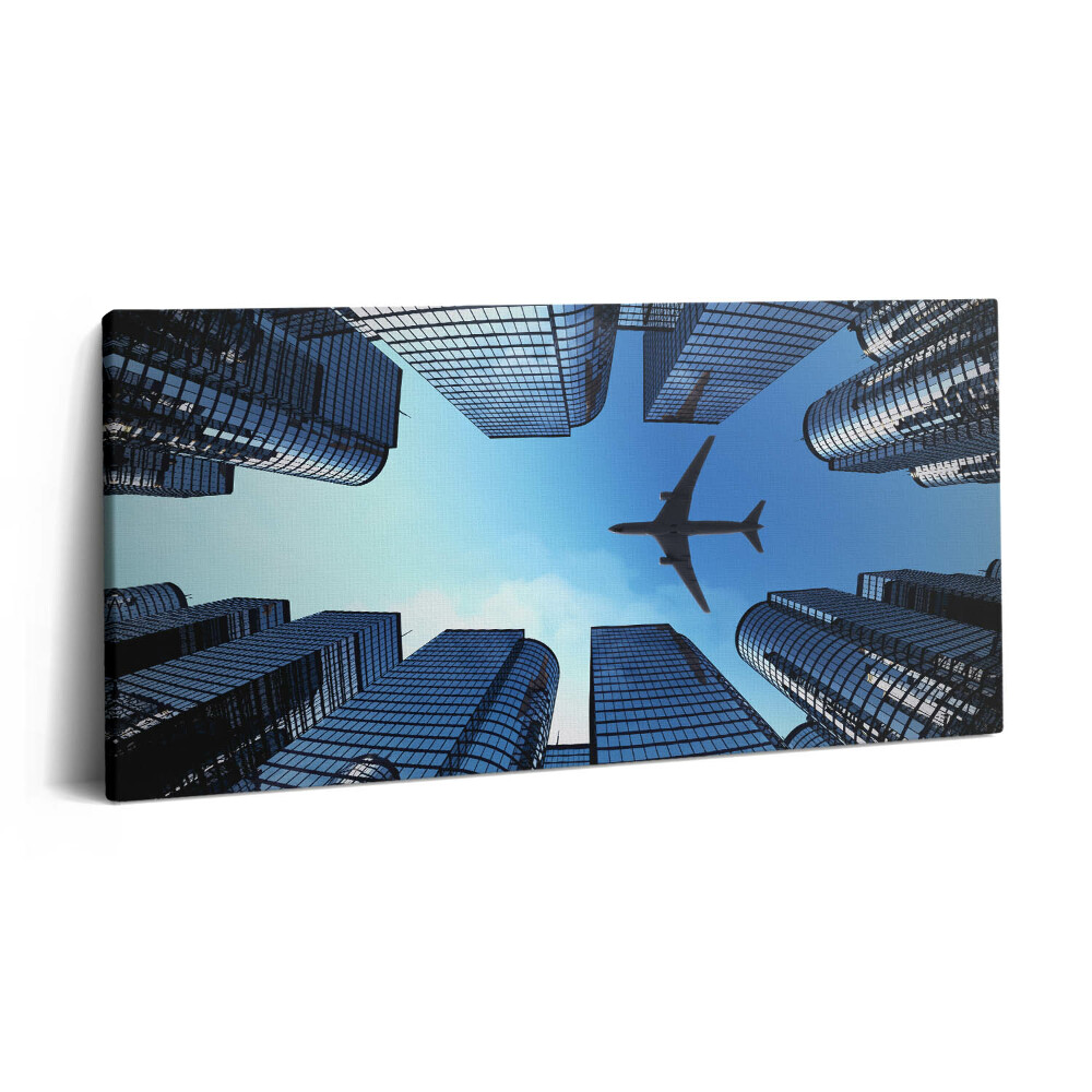 Obraz na plátne 120x60 Lietadlo nad mestskými mrakodrapmi